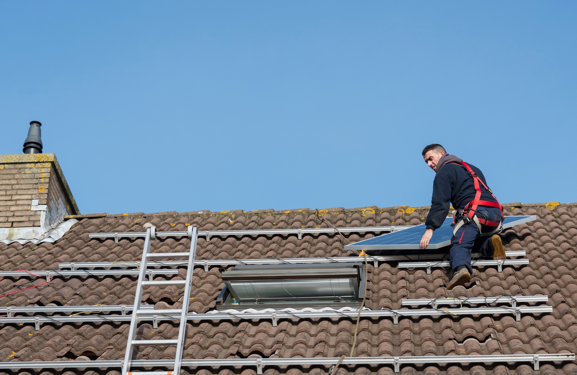 man putting the solar panel on the roof